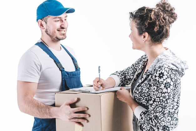 Free photo smiling woman signing for parcel near courier