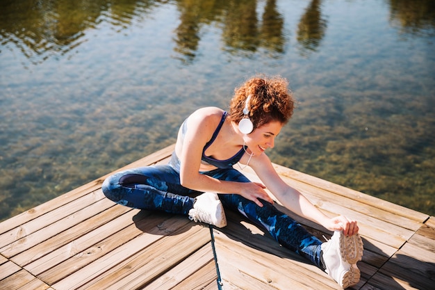 Free photo smiling woman stretching and enjoying music