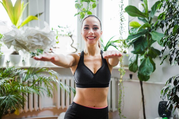 Smiling woman stretching out hands