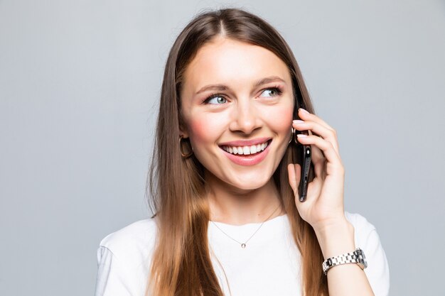 Smiling woman talking on the smart phone isolated