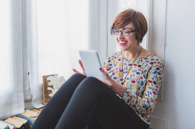 Smiling woman using her tablet