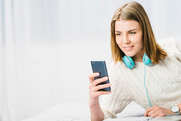 Smiling woman using smartphone