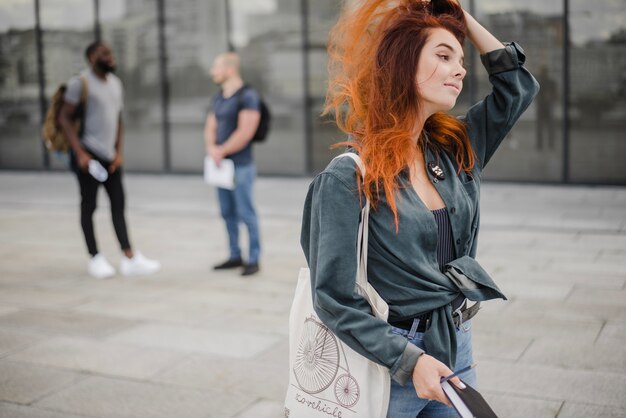 Smiling woman walking with book