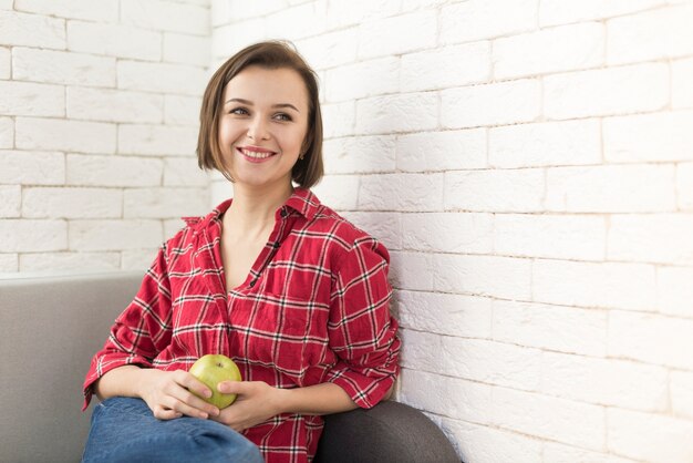 Smiling woman with apple