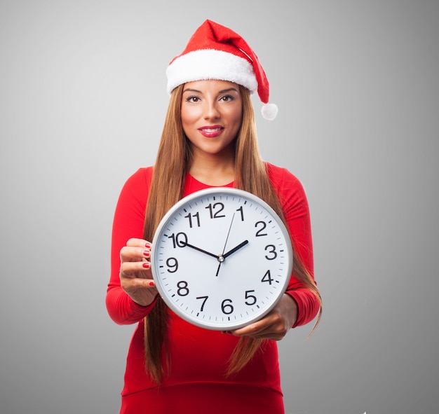 Smiling woman with a big clock