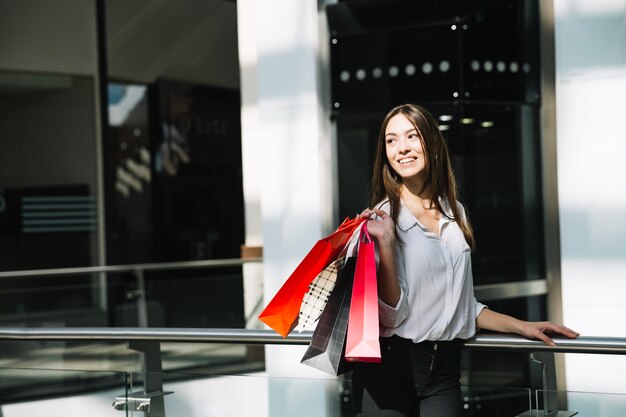 Smiling woman with colorful paper bags