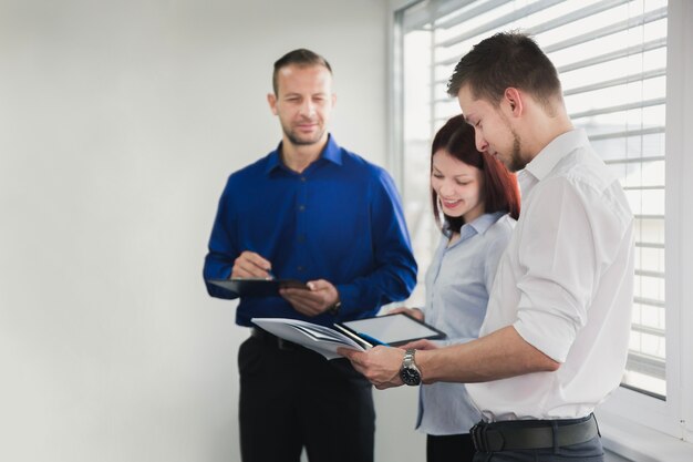 Smiling woman with coworkers in office