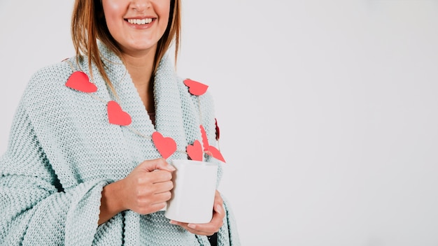 Smiling woman with cup and plaid