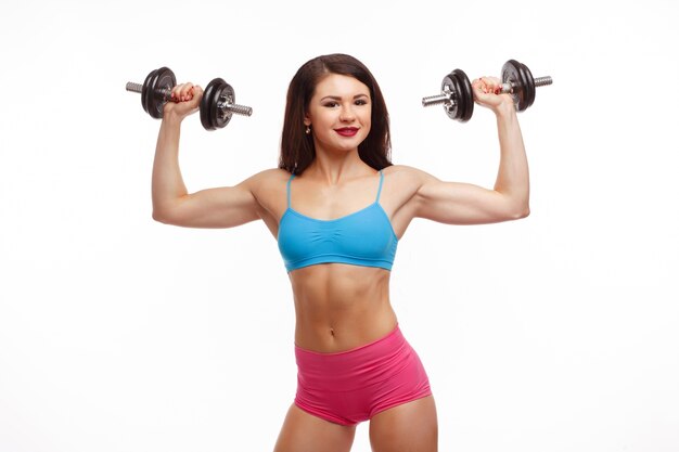 Smiling woman with dumbbells