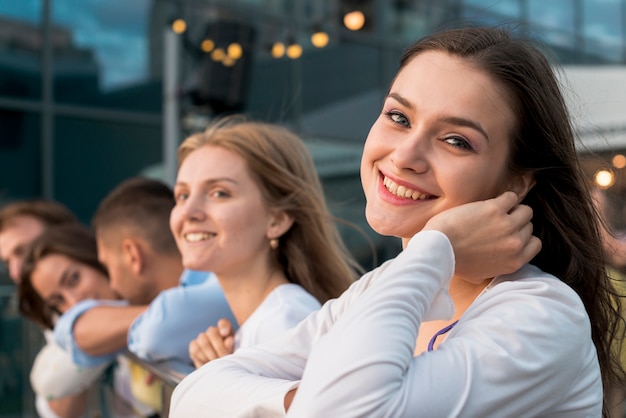 Smiling woman with friends in background