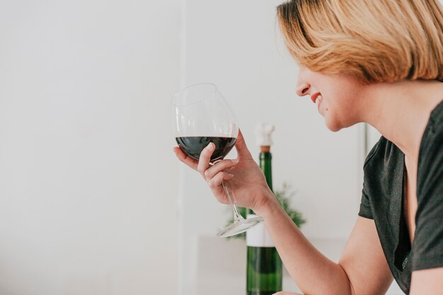 smiling woman with glass of wine