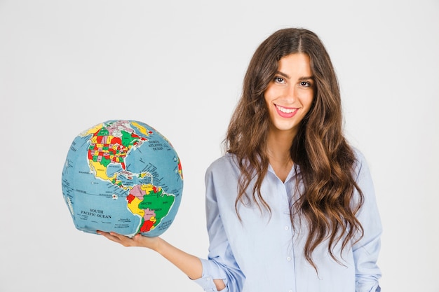 Smiling woman with globe