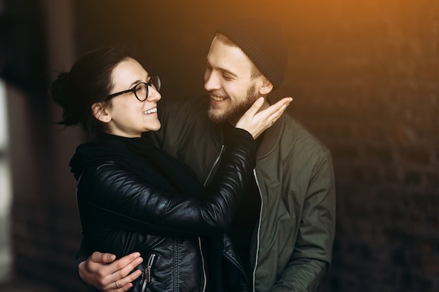 Smiling woman with her hand near her boyfriend's face