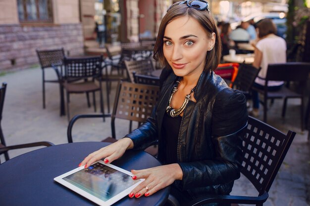 Smiling woman with her tablet on the table