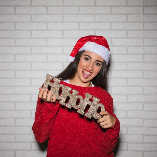 Smiling woman with Ho Ho Ho sign 