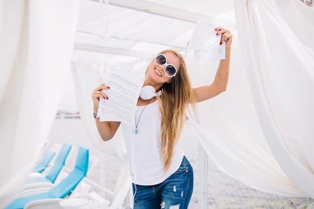 Smiling woman with music sheets