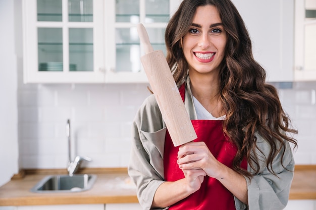 Smiling woman with rolling pin