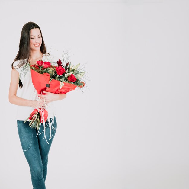 Smiling woman with roses bouquet