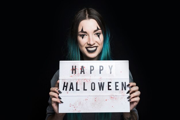 Smiling woman with signboard