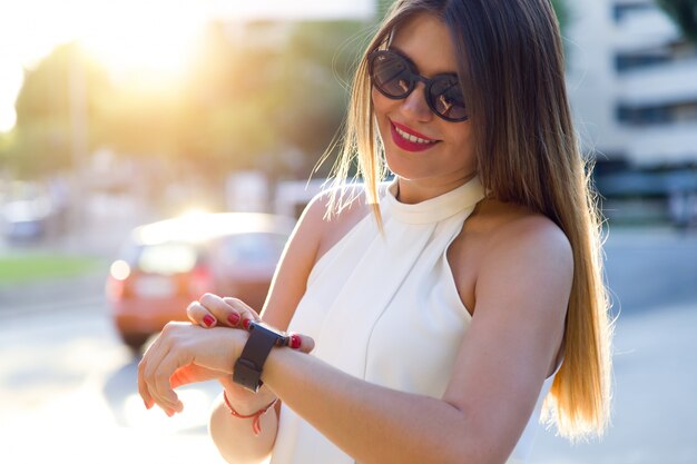 "Smiling woman with smart watch"