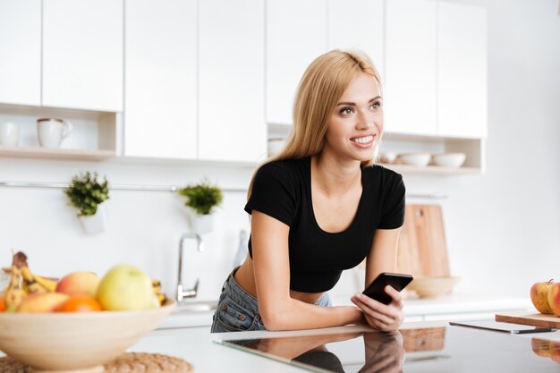 Smiling woman with smartphone