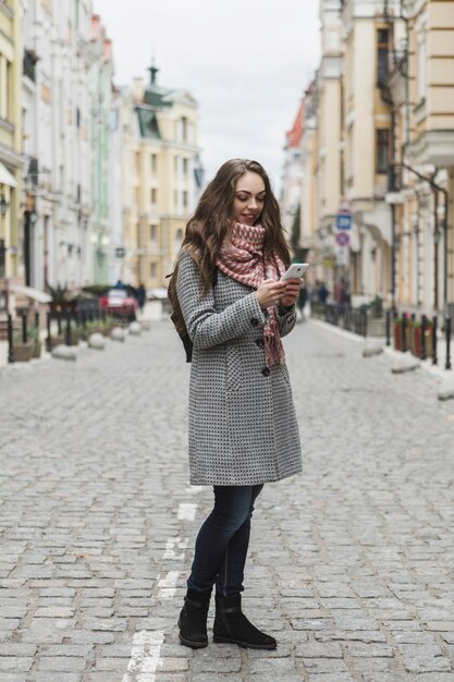 Smiling woman with smartphone