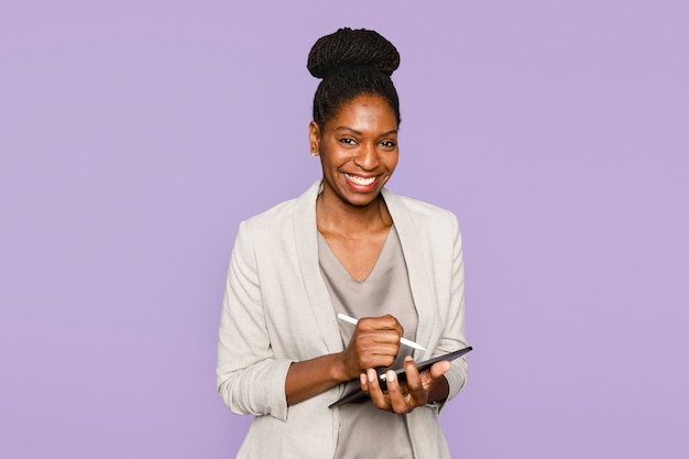 Free photo smiling woman writing notes on tablet digital device