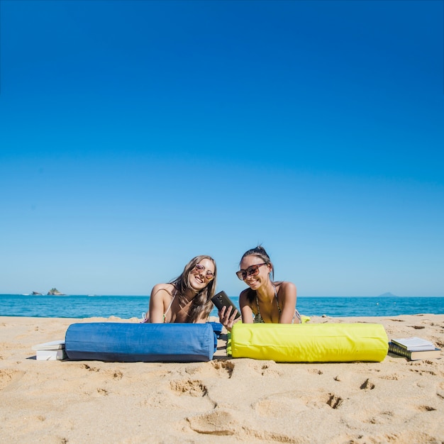 Smiling women sunbathing