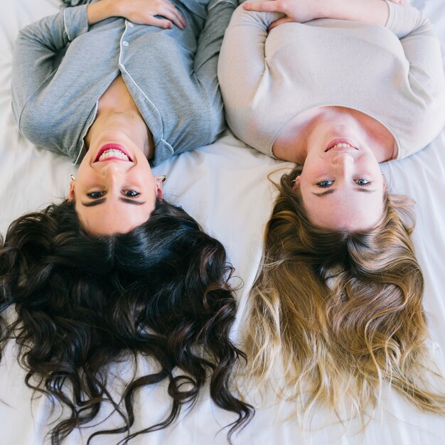 Smiling women on white sheet