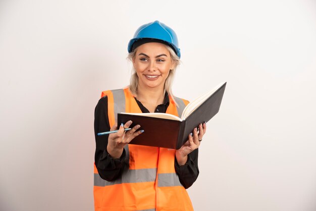 Smiling worker holding notebook on white background. high quality photo