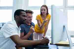 Free photo smiling worker while others look serious