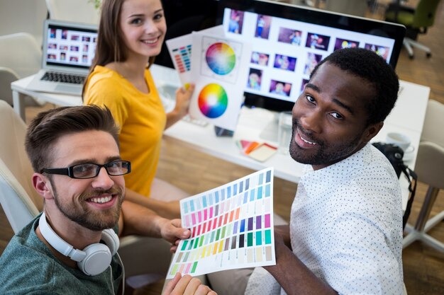 Smiling workers with color palette