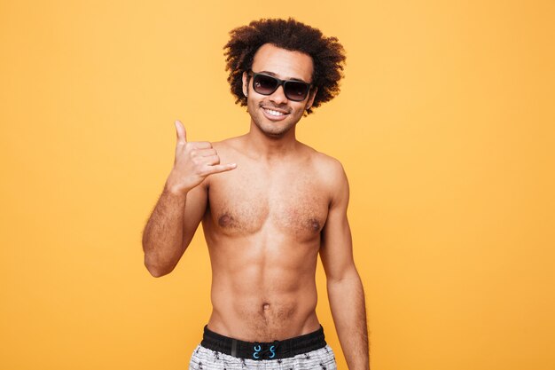 Smiling young african man gesturing with hands.