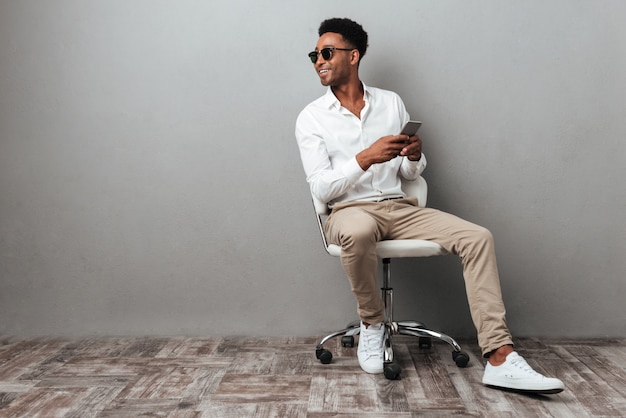 Smiling young african man sitting in a chair