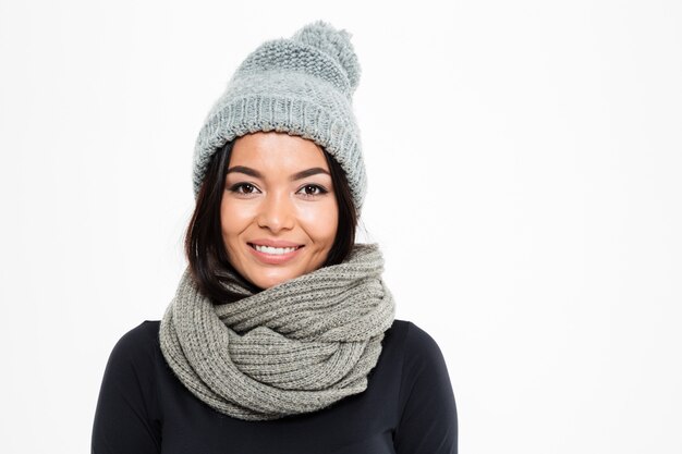 Smiling young asian lady wearing warm hat and scarf