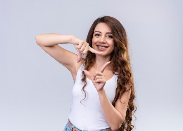 Smiling young beautiful girl doing frame gesture 