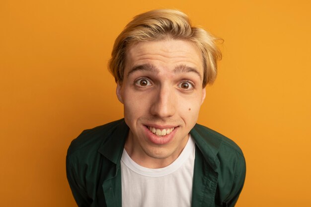 Smiling young blonde guy wearing green t-shirt