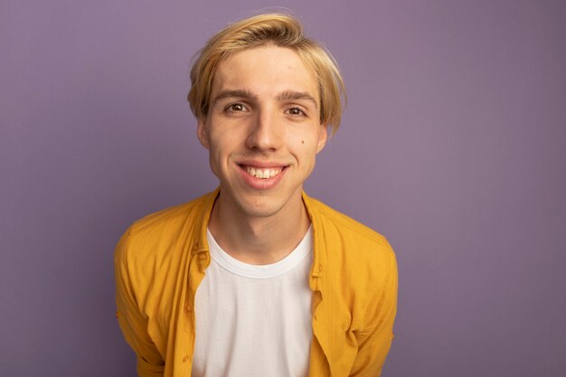 Smiling young blonde guy wearing yellow t-shirt