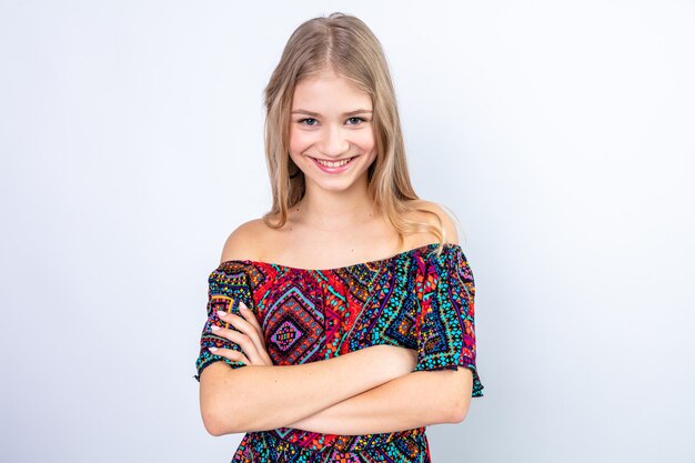 Smiling young blonde slavic girl standing with crossed arms
