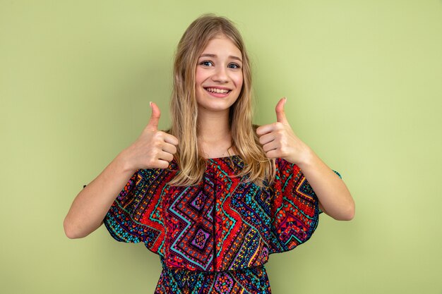 Smiling young blonde woman thumbing up 