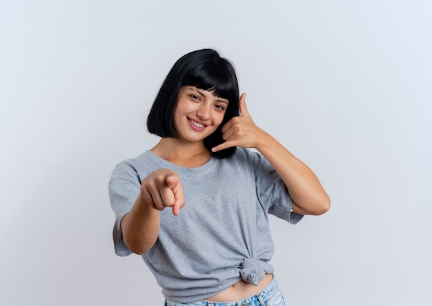 Free photo smiling young brunette caucasian woman gestures call me sign