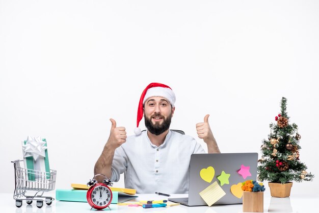 Smiling young businessman in office celebrating christmas working