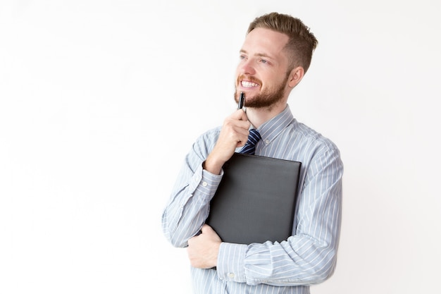 Smiling young businessman with pensive expression