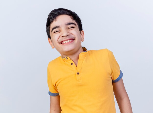 Smiling young caucasian boy with closed eyes isolated on white background with copy space