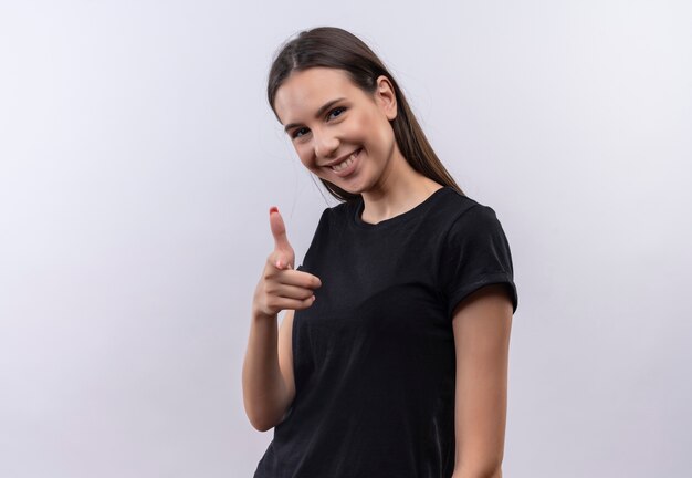 Smiling young caucasian girl wearing black t-shirt showing you gesture on isolated white background