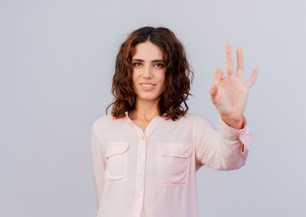 Foto gratuita la giovane donna caucasica sorridente fa un gesto ok con la mano