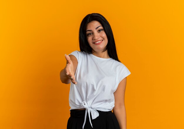 Smiling young caucasian woman holds out hand