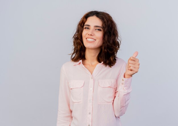 Smiling young caucasian woman thumbs up