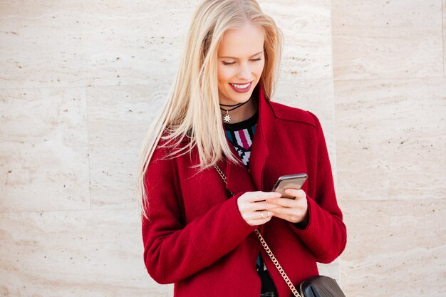 Smiling young caucasian woman walking outdoors chatting