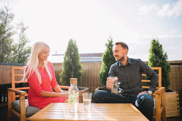 Smiling young couple enjoying the drink at outdoors